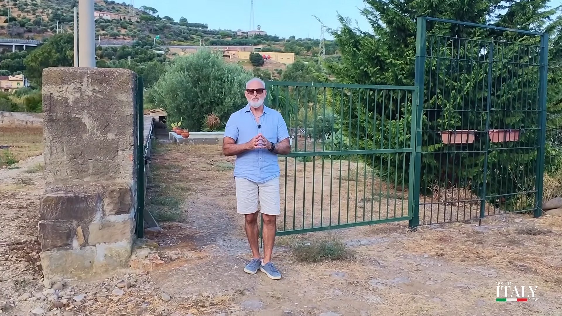 Carlo Lauria at the gate of a property in Sicily
