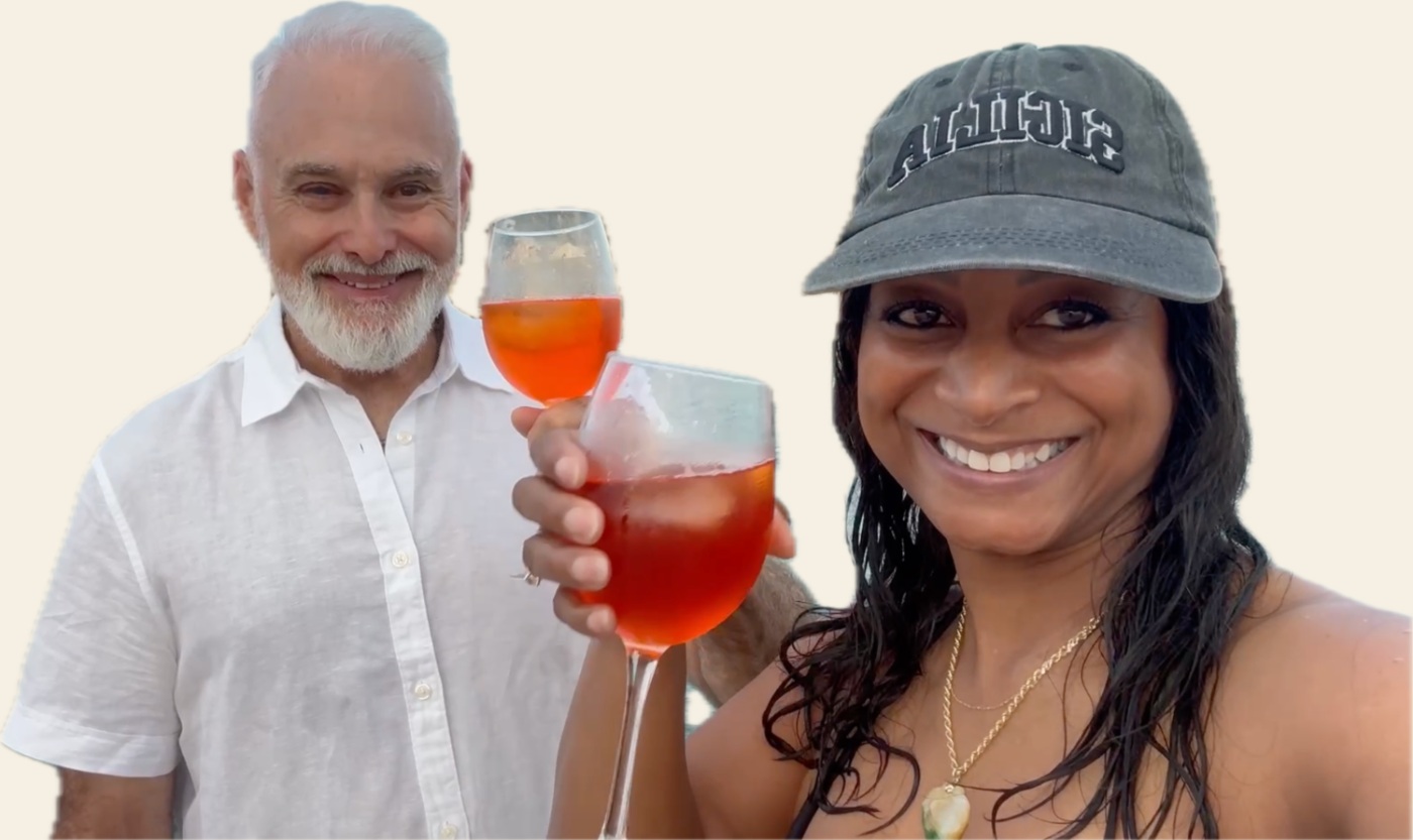 Carlo and Jeia Lauria raising a spritz by the sea in Sicily