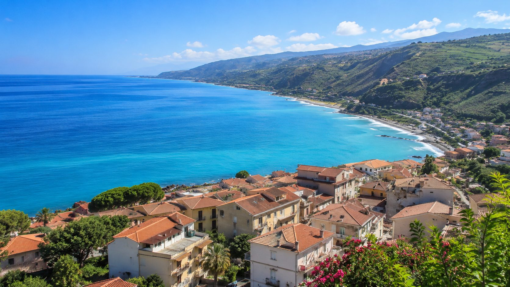 Rooftops and the bay at Tusa on Sicily's northern coast in golden light
